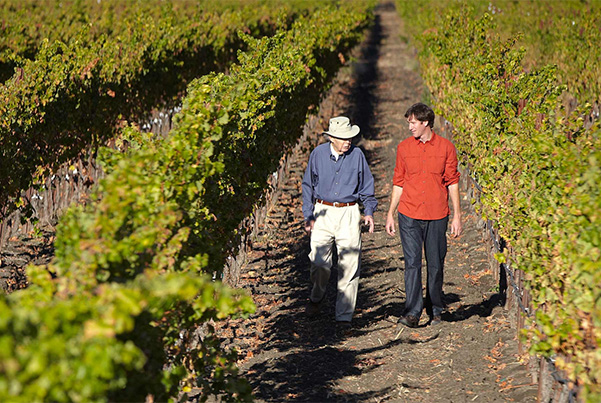 Davis Bynum and Greg Morthole walking through a vineyard